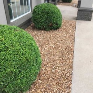 Flowerbed Rock Installation and Bush Trimming